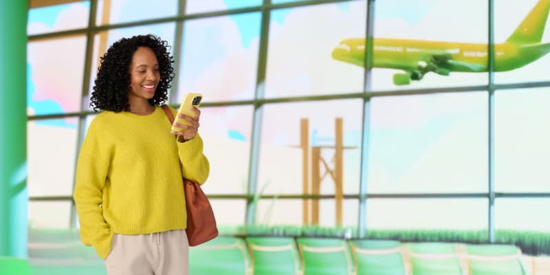 Woman viewing mobile phone at airport.