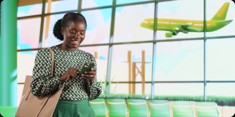 Woman checking mobile phone at airport.